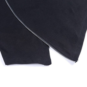 Detail of the silver-tone zipper running between the pointed black front panels at the hem.