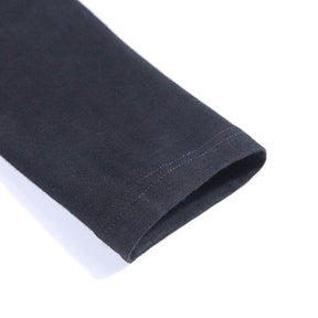 Close view of the black sleeve end and its stitched cuff on the Witchy Ninja turtleneck.