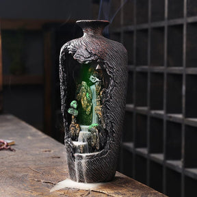 Green-lit version of the open vase incense burner, highlighting the miniature rock landscape within the brown shell.