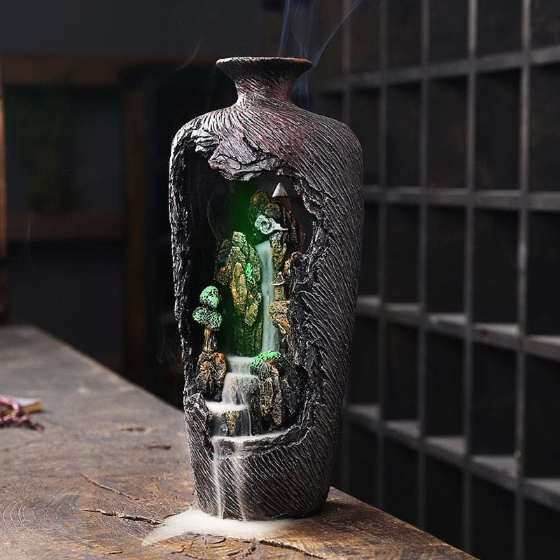 Full green-lit view of the woodland vase burner, showing the illuminated interior framed by its tall brown shell.
