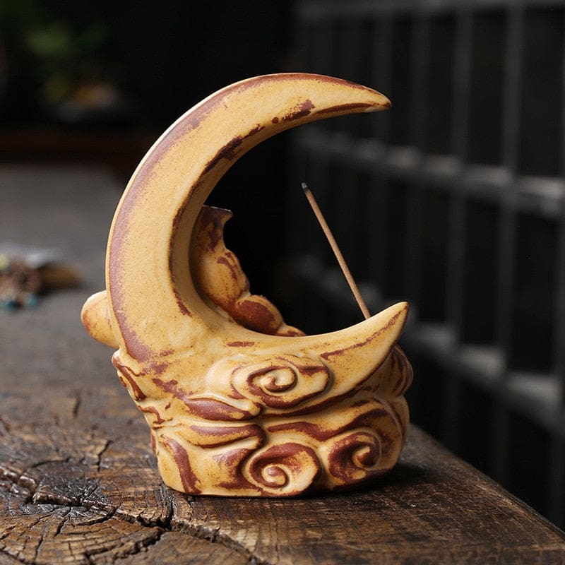 Rear view of the Yellow crescent moon incense burner, showing the plain inner curve, warm brown accents and sculpted scrolls around the base.