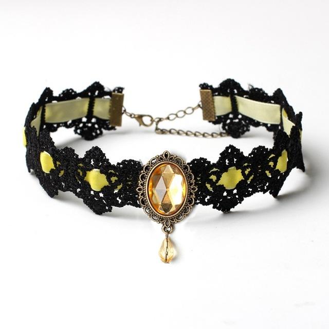 Black lace choker with an ornate oval centerpiece and hanging teardrop in the Yellow ribbon and jewel option.