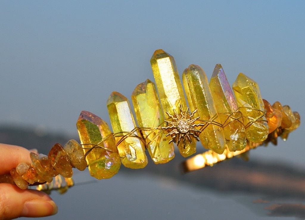 Yellow crystal point tiara with a sharp gold-tone sunburst at the centre and warm wire wrapping beneath the points.