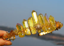 Yellow crystal point tiara with a sharp gold-tone sunburst at the centre and warm wire wrapping beneath the points.